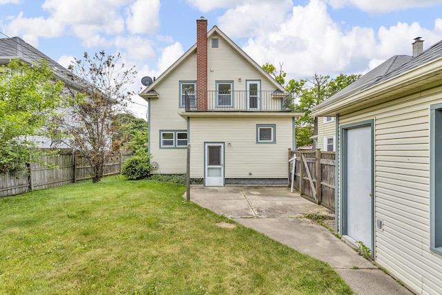 1218 Forest Ave, Jackson, MI 49201 - rear view of house with a patio area, a balcony, a fenced backyard, and a chimney