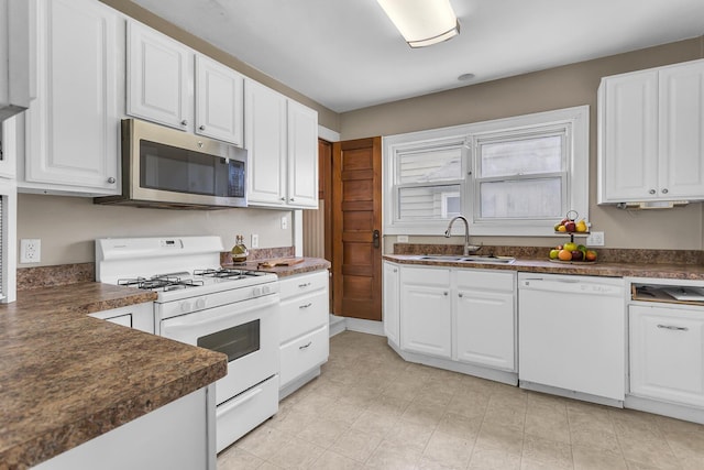 1218 Forest Ave, Jackson, MI 49201 - kitchen with white appliances, dark countertops, and white cabinetry
