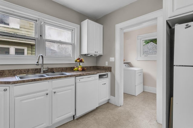 1218 Forest Ave, Jackson, MI 49201 - kitchen featuring white appliances, dark countertops, white cabinets, and separate washer and dryer