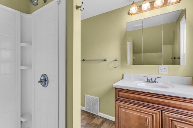 1218 Forest Ave, Jackson, MI 49201 - bathroom with a shower, vanity, and stone finish floors