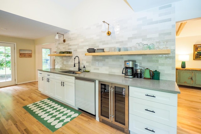 6670 Ravenswood Ave, Sawyer, MI 49125 - bar featuring beverage cooler, dishwashing machine, decorative backsplash, and light wood-style floors