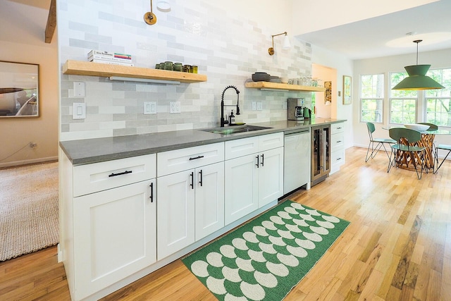 6670 Ravenswood Ave, Sawyer, MI 49125 - kitchen featuring open shelves, backsplash, dark countertops, dishwasher, and wine cooler