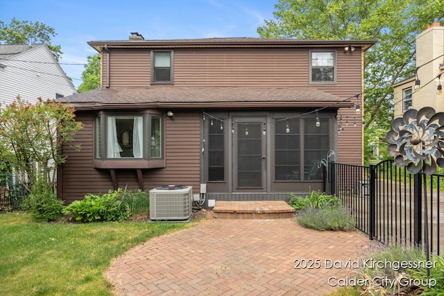 1052 Santa Cruz Dr SE, Grand Rapids, MI 49506 - rear view of house with a chimney, a patio area, and roof with shingles