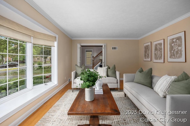 1052 Santa Cruz Dr SE, Grand Rapids, MI 49506 - living area featuring ornamental molding, light wood-type flooring, and stairway
