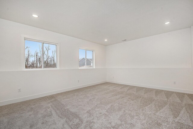 12379 Jenks St NE, Belding, MI 48809 - empty room featuring recessed lighting and light carpet