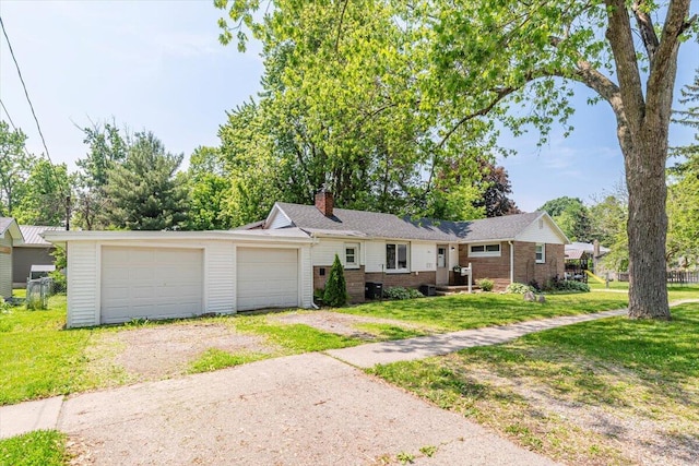 211 W S St, Grand Ledge, MI 48837 - ranch-style house with driveway, brick siding, a chimney, and a front lawn