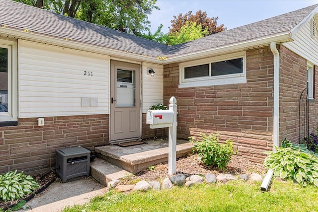 211 W S St, Grand Ledge, MI 48837 - doorway to property with a shingled roof and brick siding
