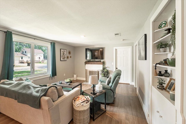 211 W S St, Grand Ledge, MI 48837 - living room with wood finished floors and a textured ceiling