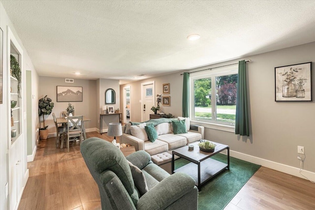 211 W S St, Grand Ledge, MI 48837 - living area featuring light wood-style floors, a textured ceiling, and recessed lighting