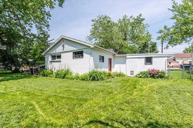 211 W S St, Grand Ledge, MI 48837 - rear view of property with concrete block siding
