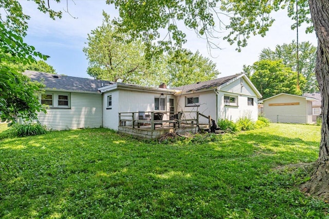 211 W S St, Grand Ledge, MI 48837 - rear view of house featuring a lawn and a detached garage