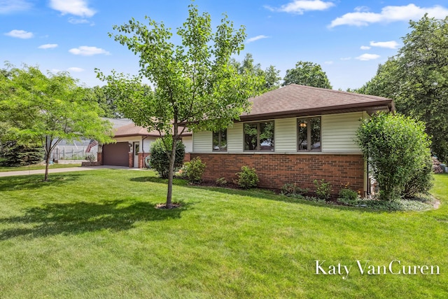 701 Novak Ln, Big Rapids, MI 49307 - ranch-style house with brick siding, a garage, a front lawn, and driveway