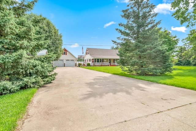 31688 Colon Rd, Colon, MI 49040 - view of front of house featuring a garage, a front yard, and an outbuilding