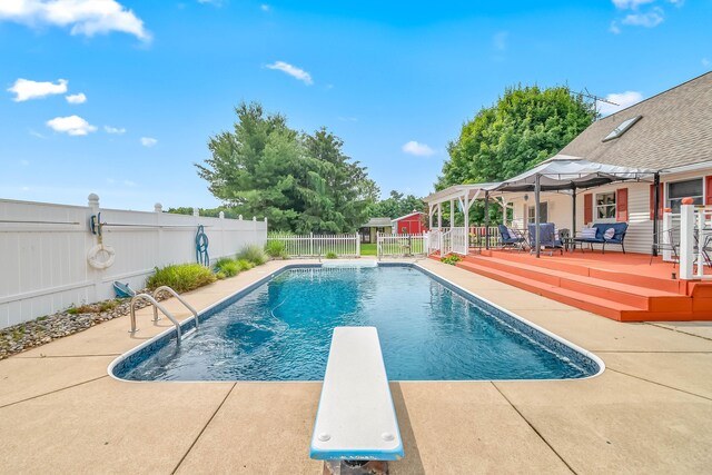 31688 Colon Rd, Colon, MI 49040 - view of pool with a fenced backyard, a wooden deck, a diving board, and a patio