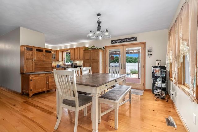 31688 Colon Rd, Colon, MI 49040 - dining space with french doors, light wood-type flooring, and a chandelier