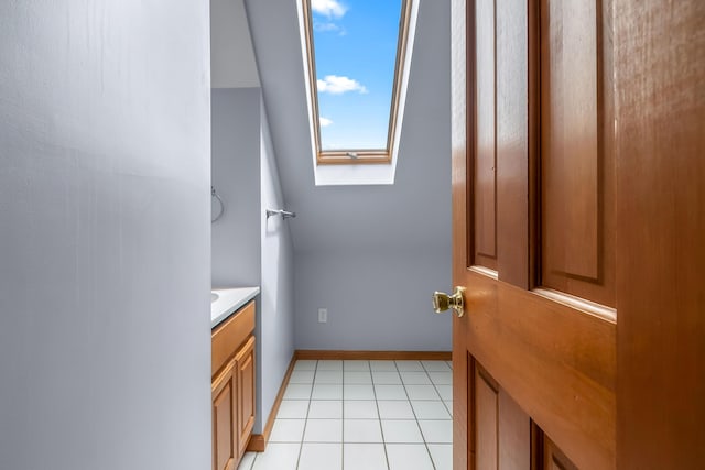 31688 Colon Rd, Colon, MI 49040 - bathroom with a skylight, vanity, and tile patterned flooring