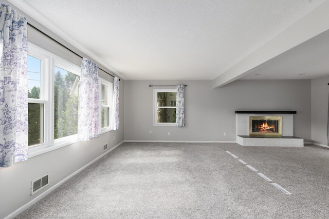 2647 Manitoba Ct NE, Grand Rapids, MI 49525 - unfurnished living room featuring carpet flooring and a fireplace