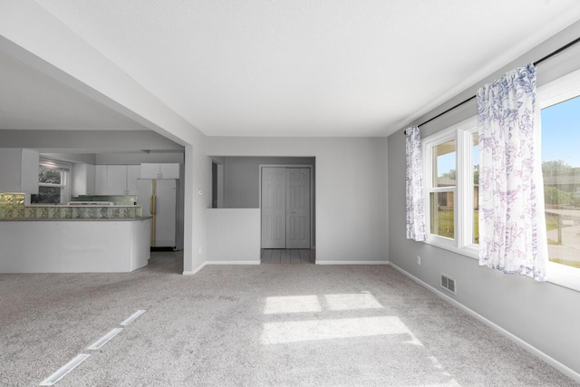 2647 Manitoba Ct NE, Grand Rapids, MI 49525 - unfurnished living room with light carpet and baseboards