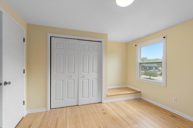 2647 Manitoba Ct NE, Grand Rapids, MI 49525 - unfurnished bedroom with wood finished floors and a closet