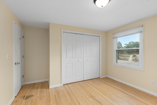 2647 Manitoba Ct NE, Grand Rapids, MI 49525 - unfurnished bedroom featuring light wood-style flooring and a closet