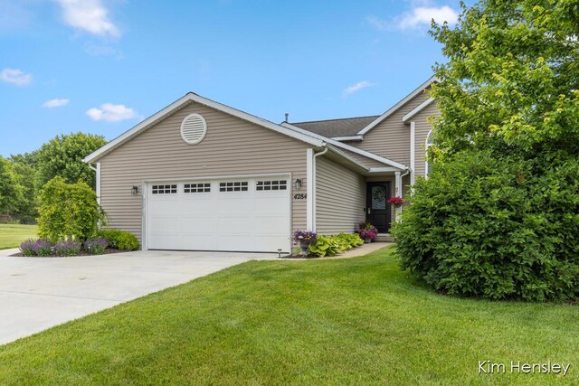 4284 Ives Farm Ln NE, Cedar Springs, MI 49319 - view of front of home featuring an attached garage, concrete driveway, and a front lawn