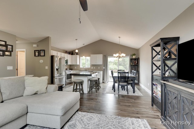 4284 Ives Farm Ln NE, Cedar Springs, MI 49319 - living area with light wood finished floors, vaulted ceiling, a chandelier, and ceiling fan