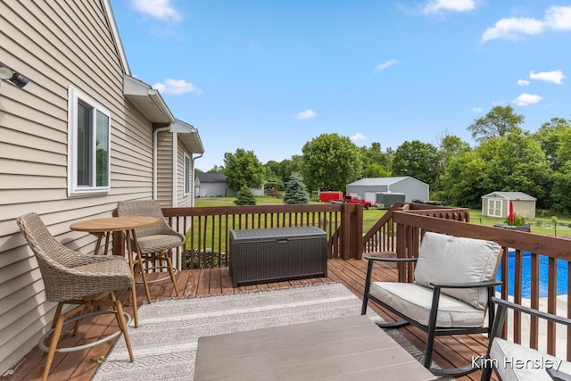 4284 Ives Farm Ln NE, Cedar Springs, MI 49319 - wooden deck featuring a storage shed, view of scattered trees, and a pool