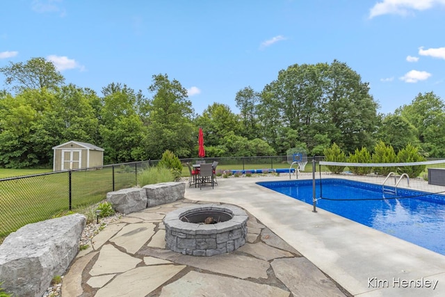 4284 Ives Farm Ln NE, Cedar Springs, MI 49319 - view of swimming pool featuring a fire pit, a storage shed, a patio, and view of wooded area