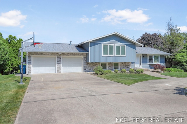 16093 Harbor Point Dr, Spring Lake, MI 49456 - split level home with a garage, concrete driveway, stone siding, and a front lawn