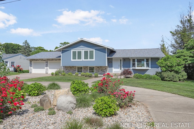 16093 Harbor Point Dr, Spring Lake, MI 49456 - split level home featuring driveway, stone siding, a garage, and a front yard