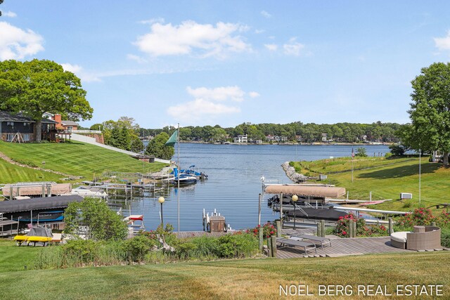 16093 Harbor Point Dr, Spring Lake, MI 49456 - dock area featuring boat lift, a water view, and a yard