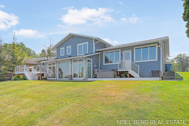 16093 Harbor Point Dr, Spring Lake, MI 49456 - rear view of house featuring stairs, a lawn, and a sunroom
