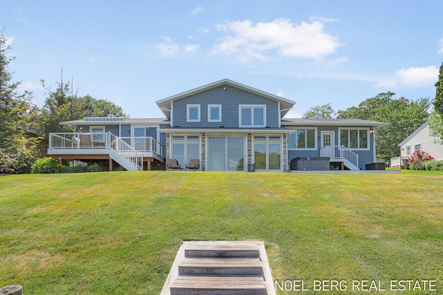 16093 Harbor Point Dr, Spring Lake, MI 49456 - back of house featuring a sunroom, a wooden deck, a lawn, and stairway