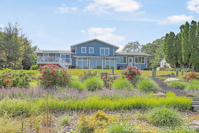 16093 Harbor Point Dr, Spring Lake, MI 49456 - back of house with stairs, a yard, and a wooden deck
