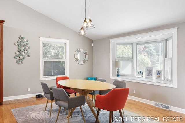 16093 Harbor Point Dr, Spring Lake, MI 49456 - dining area featuring light wood-style flooring and lofted ceiling