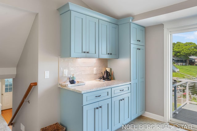 16093 Harbor Point Dr, Spring Lake, MI 49456 - kitchen featuring decorative backsplash and blue cabinetry
