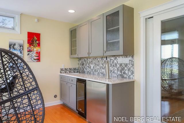 16093 Harbor Point Dr, Spring Lake, MI 49456 - indoor wet bar featuring refrigerator, wine cooler, tasteful backsplash, light wood-type flooring, and recessed lighting
