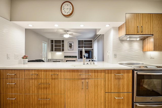 22 Haverhill Ct, Ann Arbor, MI 48105 - kitchen featuring appliances with stainless steel finishes, light countertops, a ceiling fan, backsplash, and brown cabinets