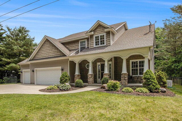 7049 S 3rd St, Mattawan, MI 49071 - craftsman-style home with a porch, a shingled roof, driveway, and an attached garage