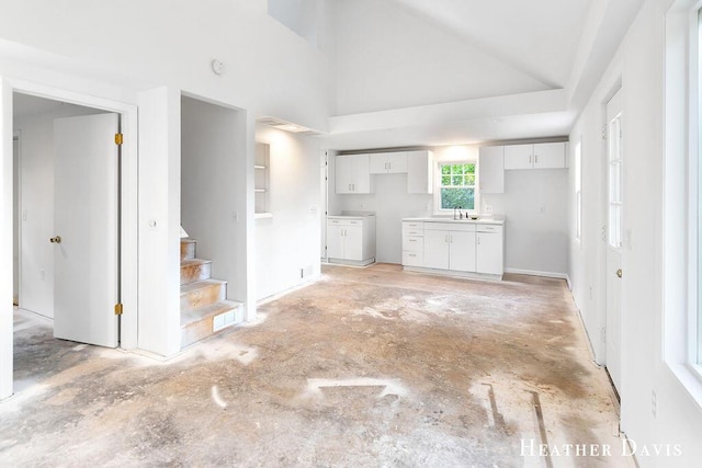 4578 135th Ave, Hamilton, MI 49419 - unfurnished living room with stairs and high vaulted ceiling