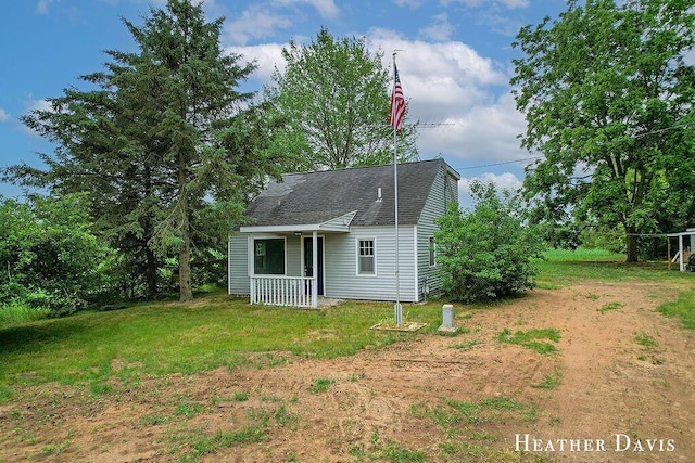 4578 135th Ave, Hamilton, MI 49419 - back of property featuring a shingled roof, a yard, and a porch