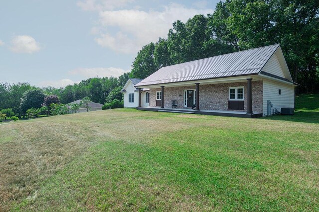 5412 Blackberry Ln, Coloma, MI 49038 - view of front of house with a front yard, brick siding, and a metal roof