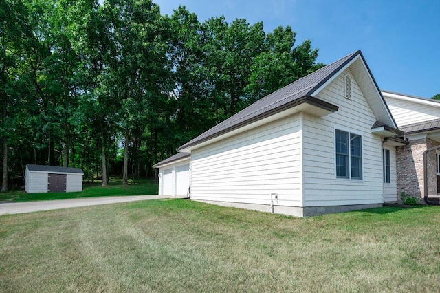 5412 Blackberry Ln, Coloma, MI 49038 - view of home's exterior featuring a lawn, a storage shed, and a garage