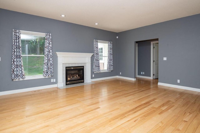 5412 Blackberry Ln, Coloma, MI 49038 - unfurnished living room featuring wood finished floors, a high end fireplace, and recessed lighting