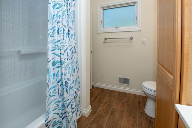 5412 Blackberry Ln, Coloma, MI 49038 - bathroom with wood tiled floors, vanity, and shower / bath combo with shower curtain
