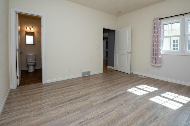 5412 Blackberry Ln, Coloma, MI 49038 - unfurnished bedroom featuring wood finished floors and connected bathroom