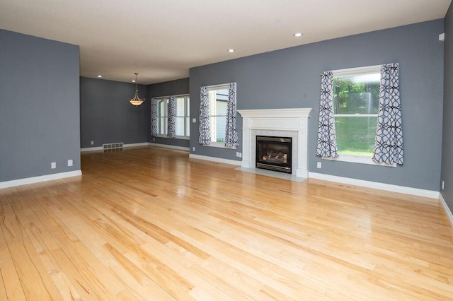 5412 Blackberry Ln, Coloma, MI 49038 - unfurnished living room with wood finished floors, a premium fireplace, and recessed lighting