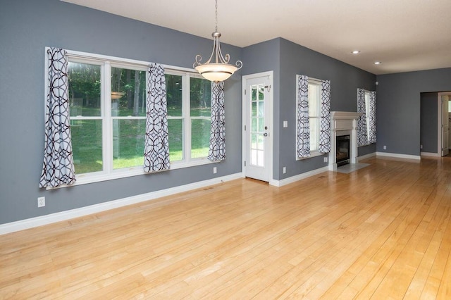 5412 Blackberry Ln, Coloma, MI 49038 - unfurnished living room featuring wood-type flooring, a fireplace with flush hearth, and recessed lighting