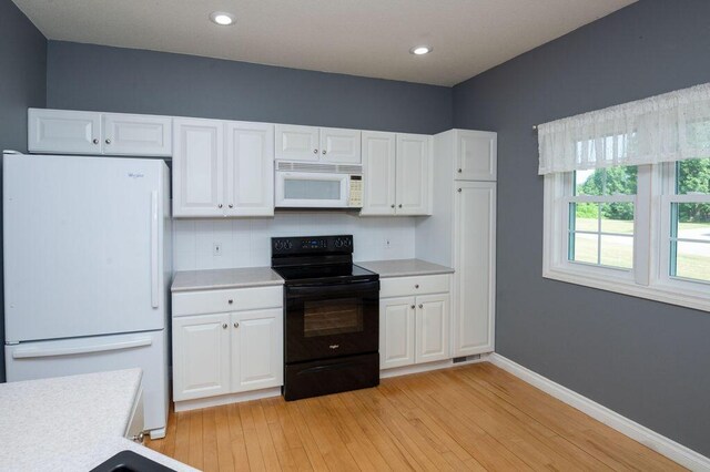 5412 Blackberry Ln, Coloma, MI 49038 - kitchen with white appliances, light countertops, light wood-style floors, white cabinets, and recessed lighting