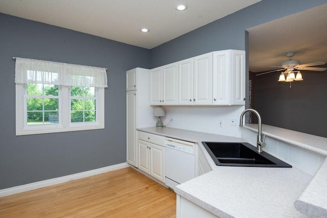 5412 Blackberry Ln, Coloma, MI 49038 - kitchen featuring white dishwasher, light wood-type flooring, light countertops, white cabinets, and recessed lighting